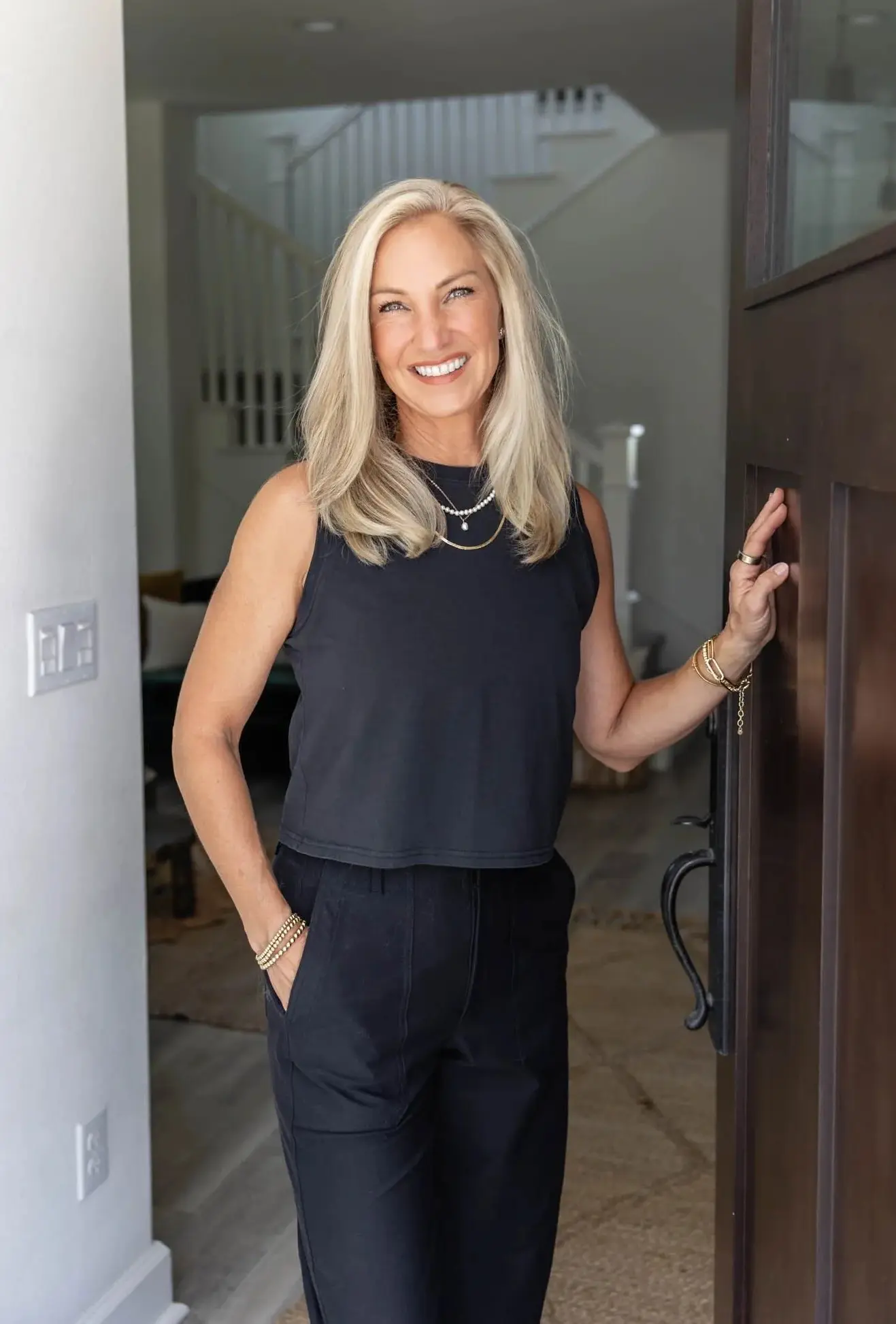 Smiling woman standing in a doorway.