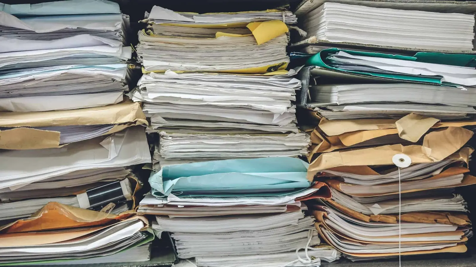 Stacks of disorganized papers and folders.