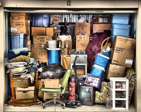 Cluttered storage unit filled with various items.